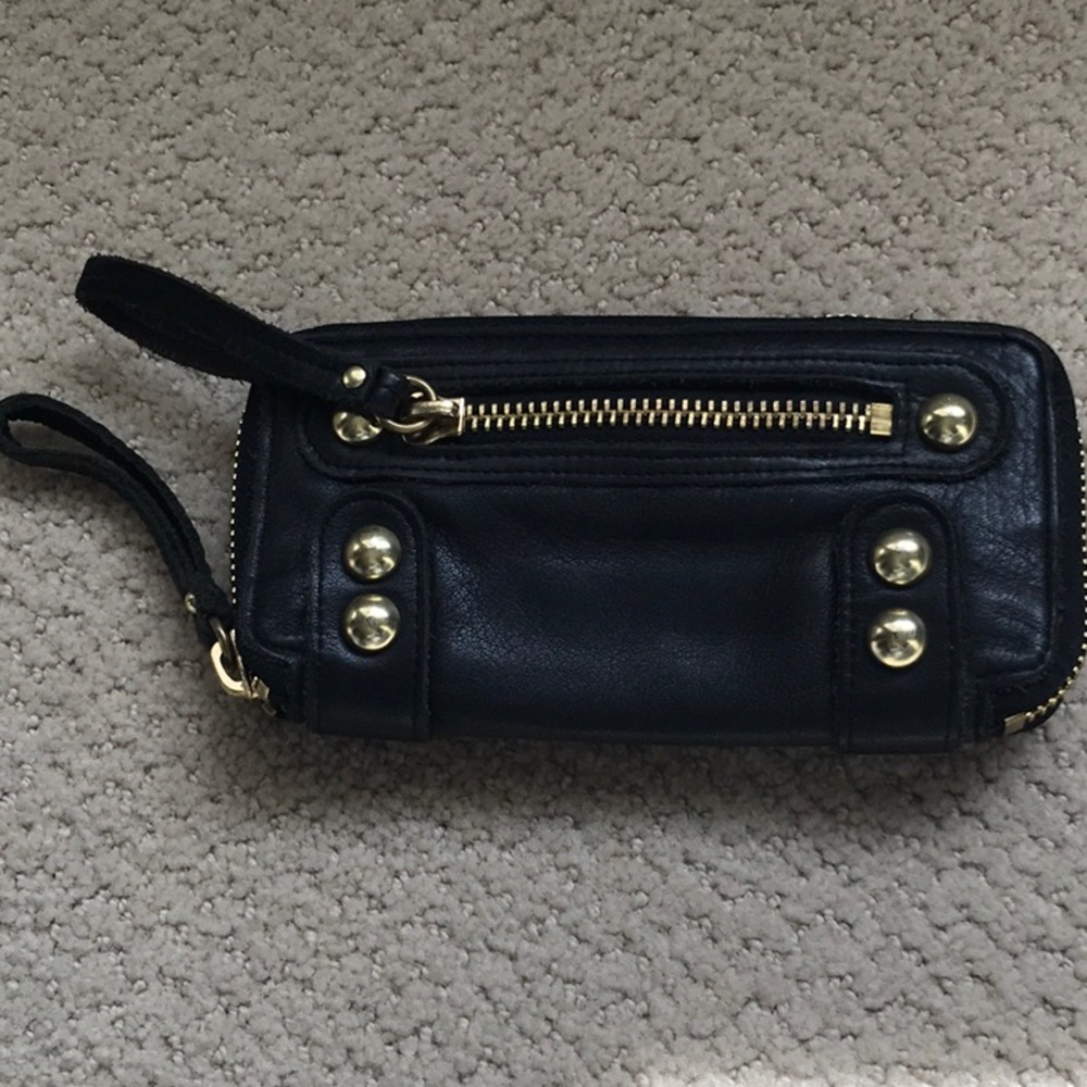 Linea pelle collection black wallet/wristlet. Gold tone studded accents.